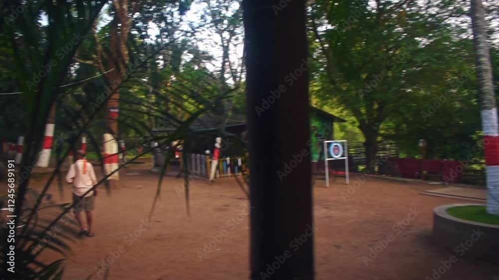 An outdoor dining area with red chairs and tables, surrounded by lush greenery under a covered roof. The warm ambient lighting and natural setting create a cozy and serene atmosphere. An outdoor dining area with red chairs and tables, surrounded by lush greenery under a covered roof. The warm ambient lighting and natural setting create a cozy and serene atmosphere.
