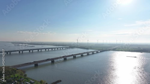 Wallpaper Mural Moerdijk bridge with wind turbines and sunlight reflecting on the water, aerial view Torontodigital.ca
