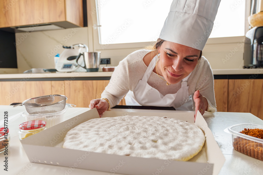 Professional pastry chef wearing white hat examining golden brown cake, demonstrating expertise in commercial kitchen setting Professional pastry chef wearing white hat examining golden brown cake, demonstrating expertise in commercial kitchen setting
