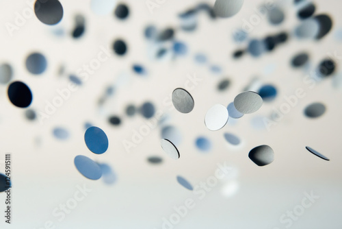 A hole punch creating paper circles that bounce away like tiny marbles