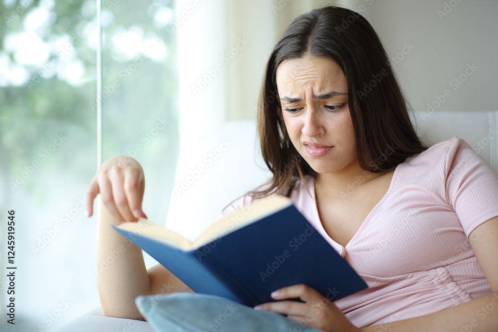 Confused woman reading a paper book at home Confused woman reading a paper book at home