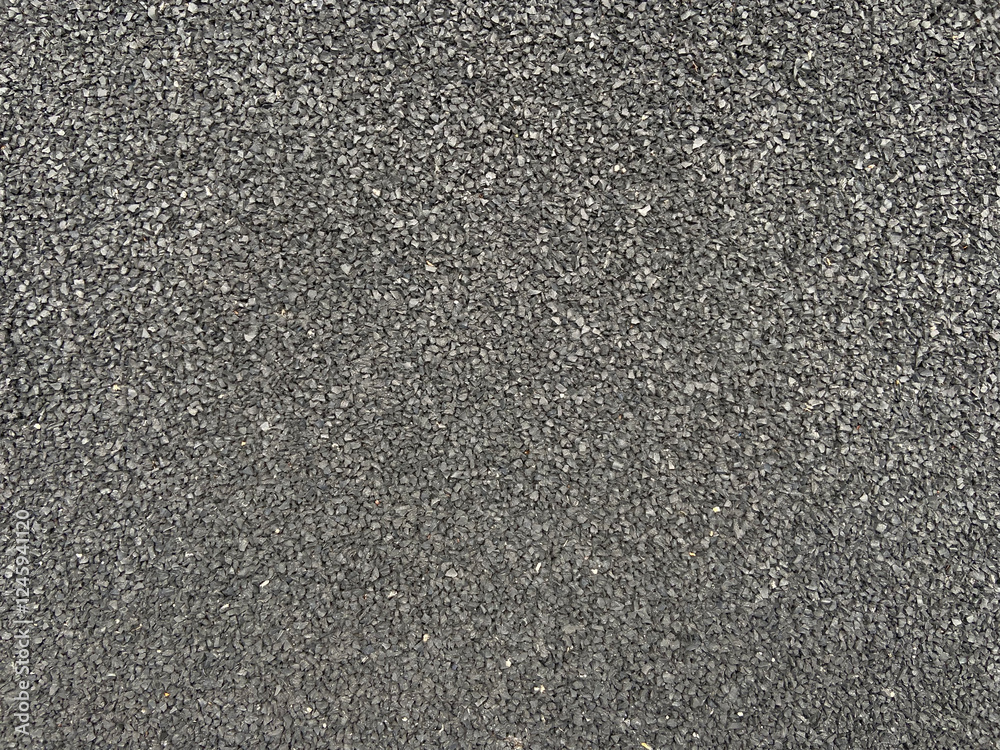 Textured surface of fine gravel in uniform gray. Textured surface of fine gravel in uniform gray.