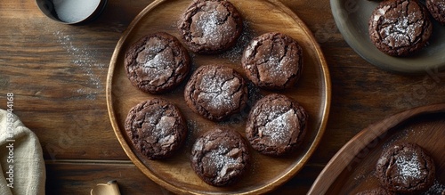 Chocolate brownie cookies arranged on a wooden plate showcasing a delicious dessert for food photography or bakery advertising photo