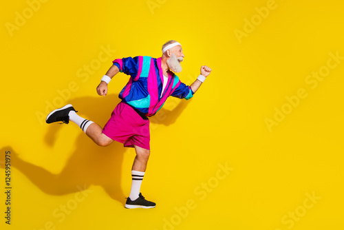 Full length photo of sportive cool modern pensioner dressed vintage jacket runing fast emtpy space isolated yellow color background photo