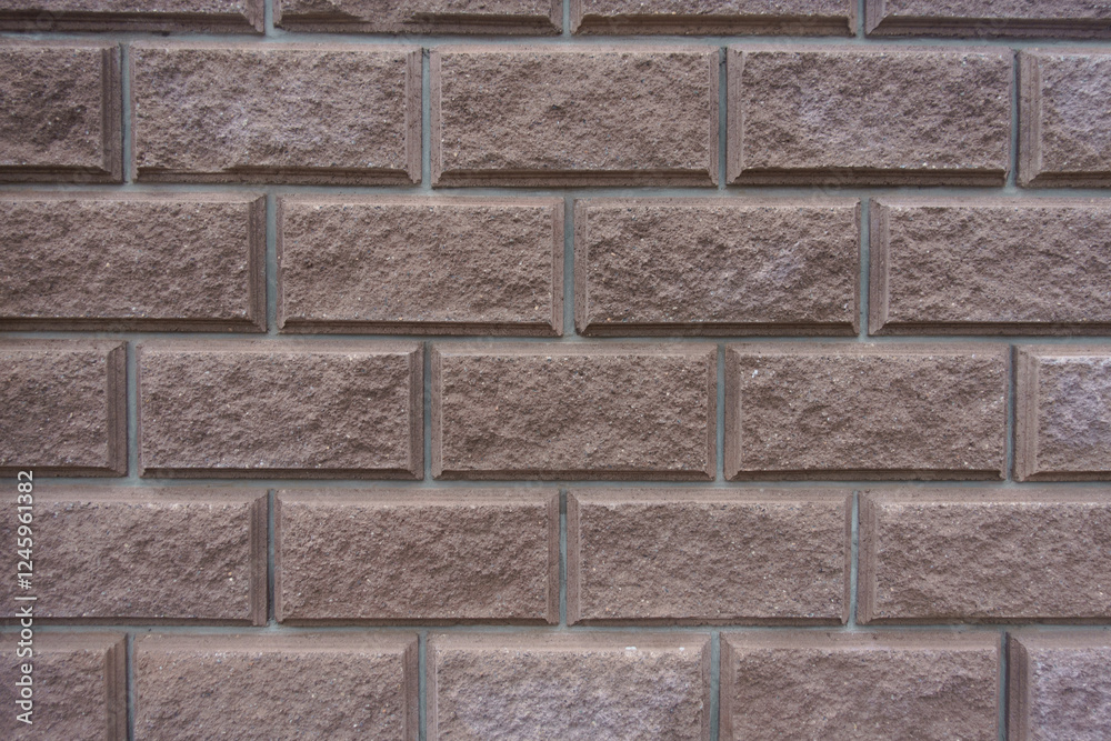 Obraz premium Background - brownish pink split face brickwork with stretcher bond pattern
