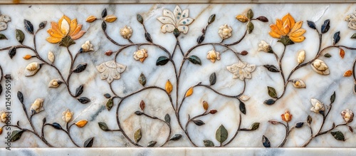 Intricate marble surface featuring stone inlay floral designs at Itimad Ud Daulah tomb Agra India showcasing fine craftsmanship and artistry. photo