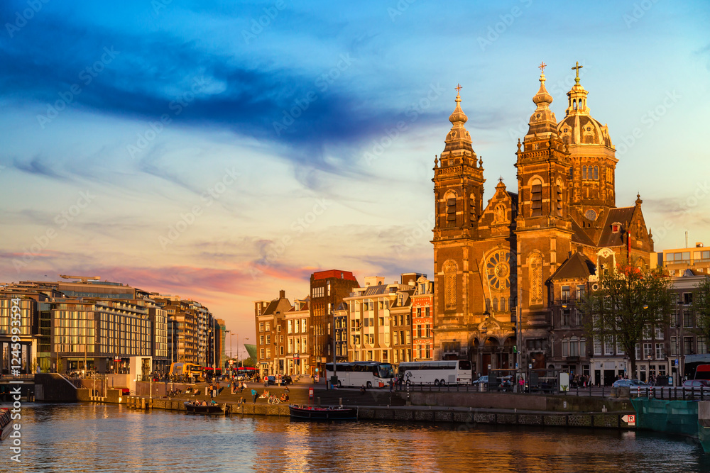Canal and St Nicholas Church in Amsterdam at colorful sunset ,Netherlands. Famous Amsterdam landmark near Central Station. Canal and St Nicholas Church in Amsterdam at colorful sunset ,Netherlands. Famous Amsterdam landmark near Central Station.