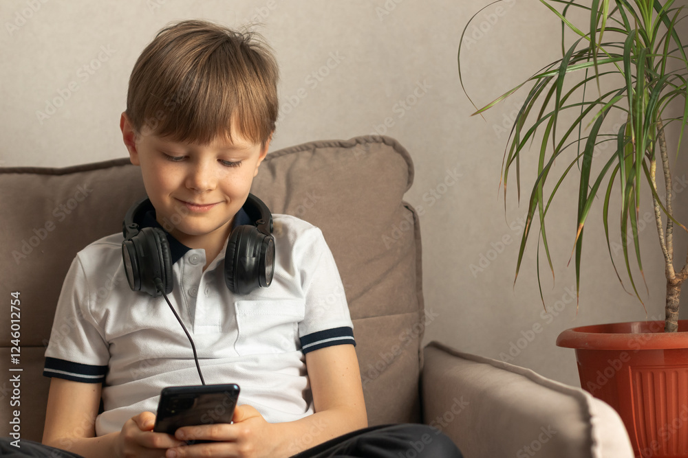 Child using smartphone at home. Little child playing video game in the room. Child using smartphone at home. Little child playing video game in the room.
