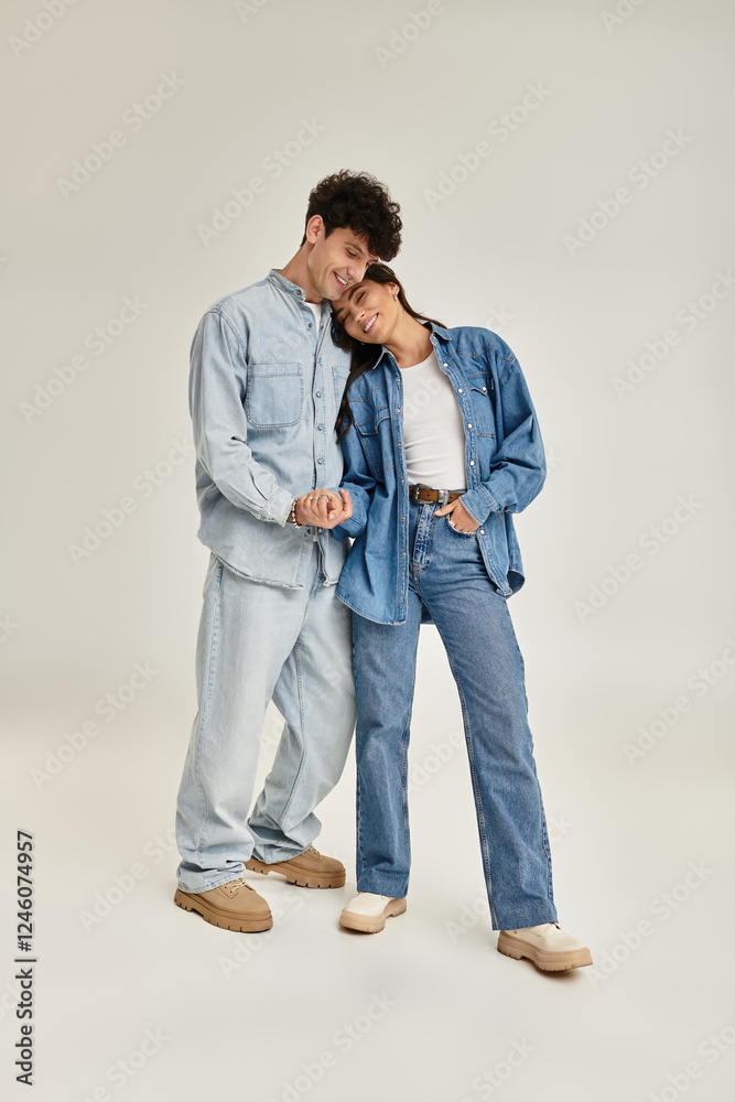 Stylish young couple sharing a moment in trendy denim outfits at a modern studio Stylish young couple sharing a moment in trendy denim outfits at a modern studio
