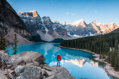 Man at Moraine lake at sunrise, Banff, Canada