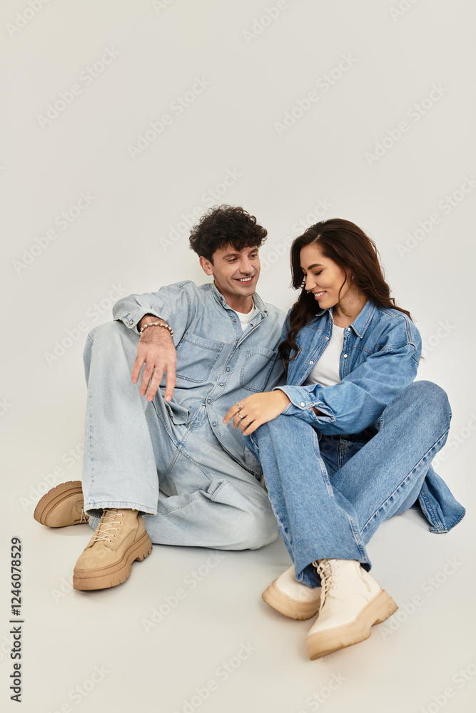 Stylish young couple embraces trendy fashion in a serene indoor setting Stylish young couple embraces trendy fashion in a serene indoor setting