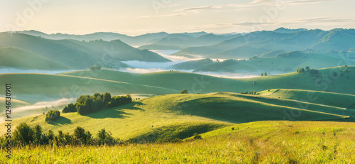 Panoramic morning landscape, fog and hills, spring greenery	