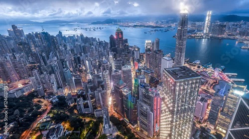 Wallpaper Mural 4K video zooming in direction over Hong Kong at dusk. Cityscape glows with lights. Torontodigital.ca