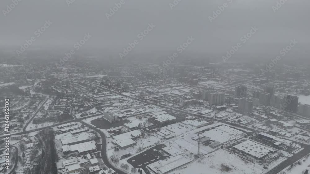 view of ice-covered city under snowfall and heavy fog during a deep winter season in Waterloo