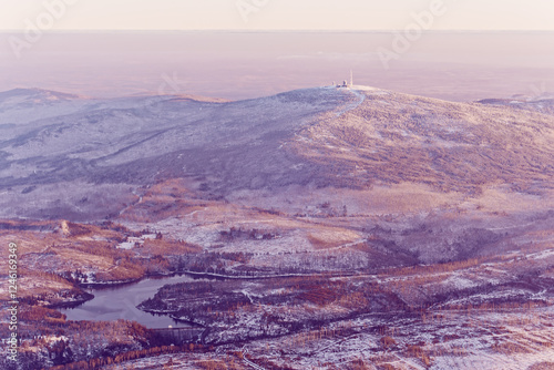 Aerial view of Mount Brocken in winter, the highest peak of the Harz mountains in Germany. In the foreground Ecker Reservoir and Ecker Dam near Bad Harzburg, Lower Saxony and Saxony-Anhalt, Germany. 