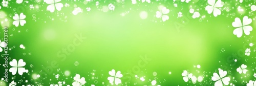 Green background with white clover leaves and soft bokeh lights concept