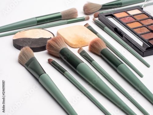 Detail Stylish green theme makeup brushes with cosmetic, flat lay. Space for text
Professional decorative cosmetics, make-up products and accessories, Eyeshadow,liptint, concealer Makeup photo