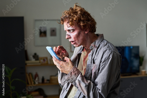 Young Male Undead Using Smartphone photo