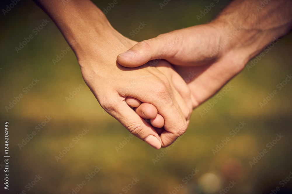 Close-up of a couple in love holding each other's hands while walking Close-up of a couple in love holding each other's hands while walking