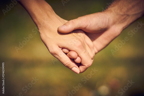 Close-up of a couple in love holding each other's hands while walking