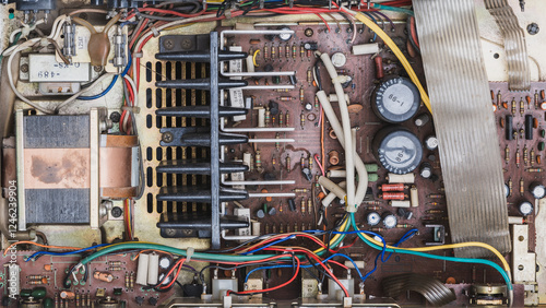 A photo of the circuit board of an old vintage integrated stereo amplifier from the 1980s in its original condition before repair.