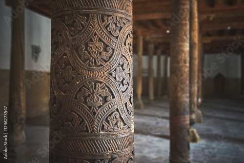 Old wooden pillar in Juma Mosque of Ichan Kala heritage town photo