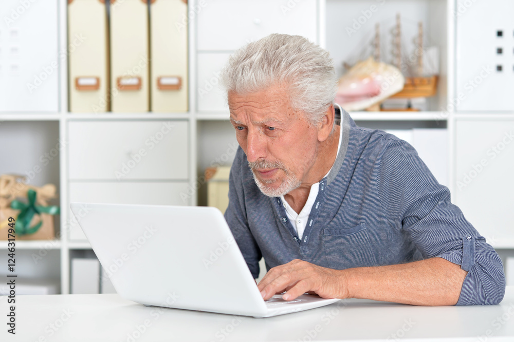 Portrait of senior man with laptop at home Portrait of senior man with laptop at home