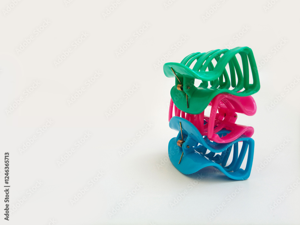 3 Colorful plastic hair claw clips pile up on white background with empty space. Woman hair accessories. Trendy accessory. Fashionable accessory 3 Colorful plastic hair claw clips pile up on white background with empty space. Woman hair accessories. Trendy accessory. Fashionable accessory