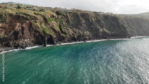 A black sand beach and cliffs, formed from solidified lava, stand as a testament to the volcanic history of São Miguel Island. Azores