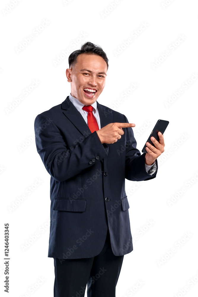 Portrait of an Asian businessman pointing to his mobile phone isolated over a white background. Concept of Indonesian business and technology Portrait of an Asian businessman pointing to his mobile phone isolated over a white background. Concept of Indonesian business and technology