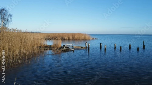 drone footage of an old rack with water and blue sky