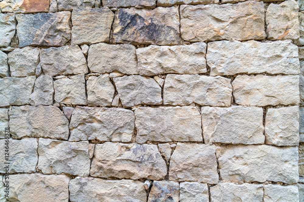 Fototapeta premium A wall made of stone with a rough texture