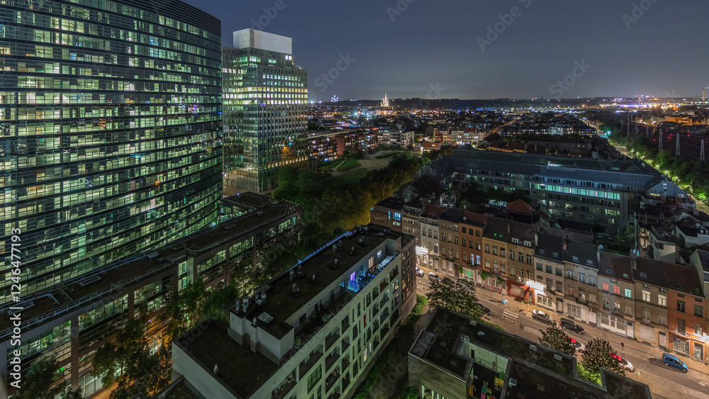 Obraz premium Aerial night timelapse of Brussels urban landscape blending office skyscrapers with residential areas.