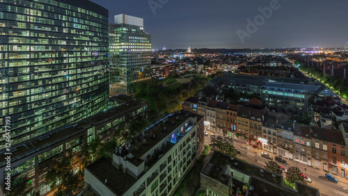 Aerial night timelapse of Brussels urban landscape blending office skyscrapers with residential areas. photo