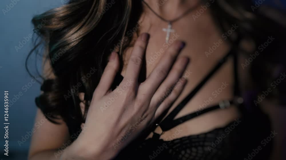 Dark moody portrait of a young beautiful girl in lingerie. The girl strokes herself and touches her breasts. Dark moody portrait of a young beautiful girl in lingerie. The girl strokes herself and touches her breasts.