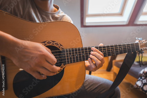 Wallpaper Mural Man alone in the middle of a sunlit room enjoys playing a beautiful wooden acoustic guitar and composing new songs. Immersed in the sweet tones of the guitar. Music that heals the soul Torontodigital.ca