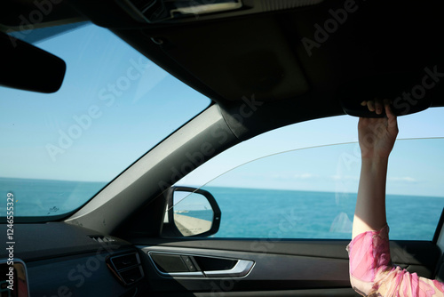 Wallpaper Mural Car passenger holding handle while traveling along a scenic ocean coastline, Florida Keys, USA Torontodigital.ca