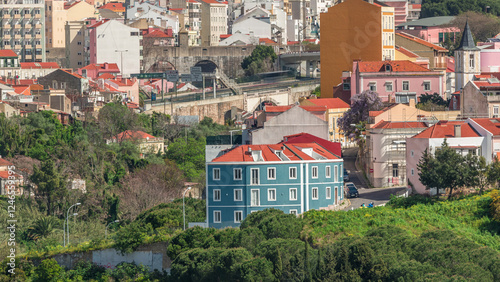 Aerial view of Lisbon skyline with road and aqueduct. Historic buildings near Campo de Ourique district with green trees timelapse photo