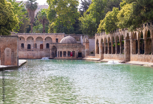 Sanliurfa, Turkey - June 19, 2023 : Balıklıgöl (Balık Lake) and Rizvaniye Mosque Landscape in beautiful sunset scenery in Şanlıurfa, Turkey. photo