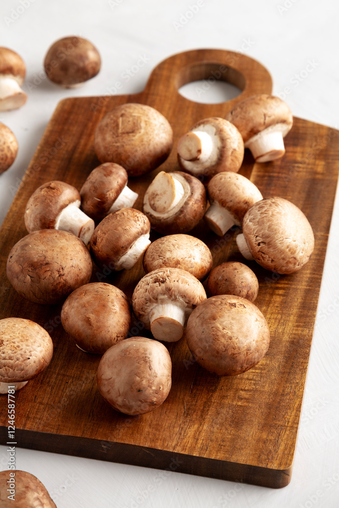 Raw Royal Brown Champignon on a wooden board, side view.