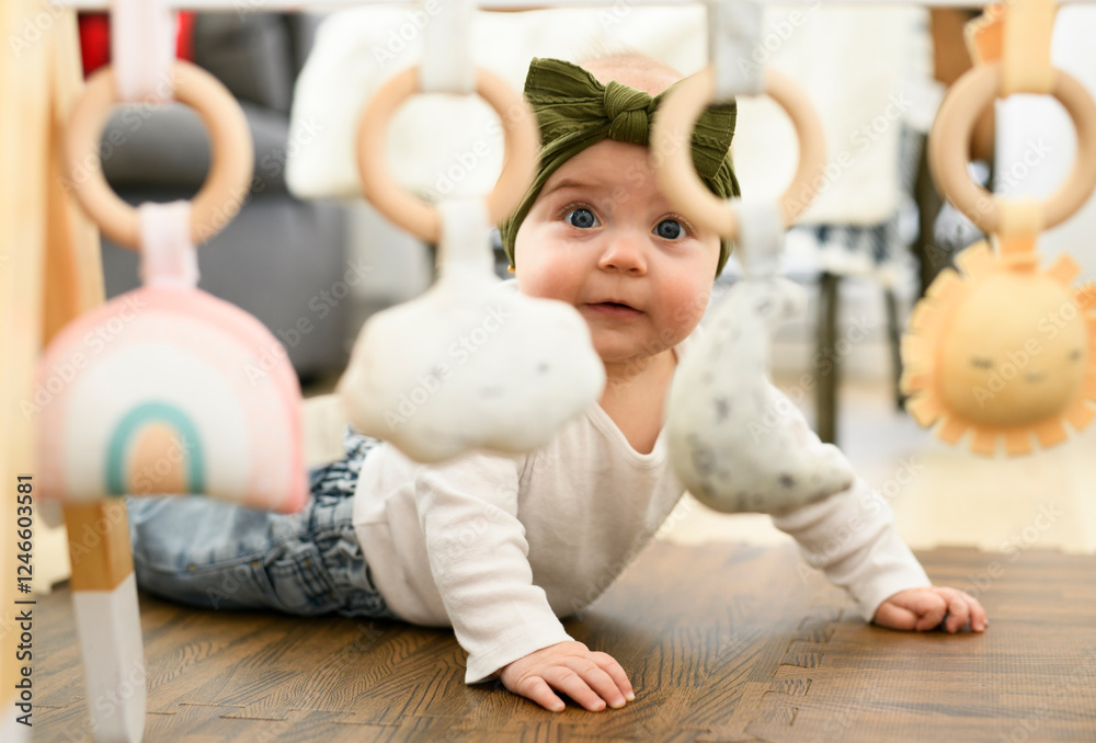 Happy cute toddler baby playing with kids toys at home on floor in living room Happy cute toddler baby playing with kids toys at home on floor in living room
