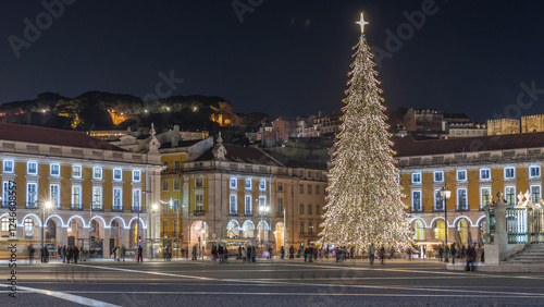 Commerce Square in Lisbon illuminated at Christmas hyperlapse, with a towering tree and crowds celebrating at night. Portugal photo