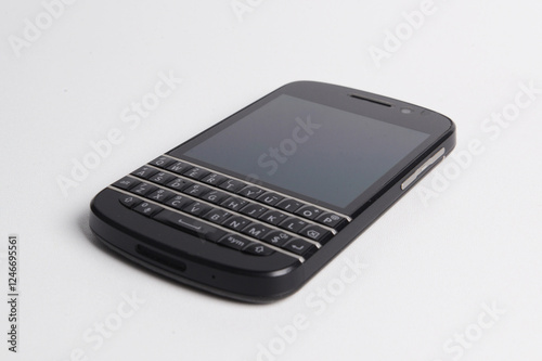 Old mobile phone with black screen, isolated on white.