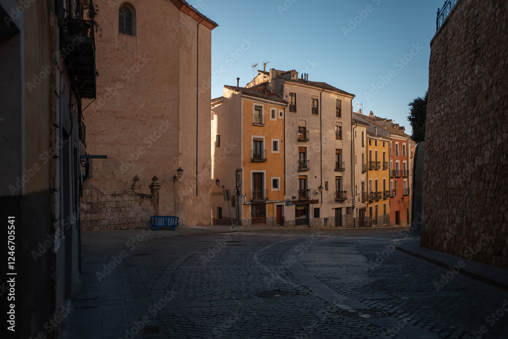 Naklejka premium cozy street of ancient European town, sunset over historic buildings