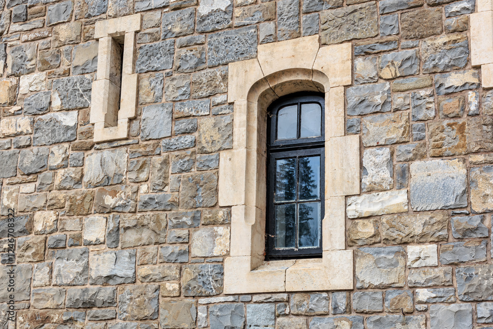 Historic stone castle wall with arched window and rustic architecture Historic stone castle wall with arched window and rustic architecture