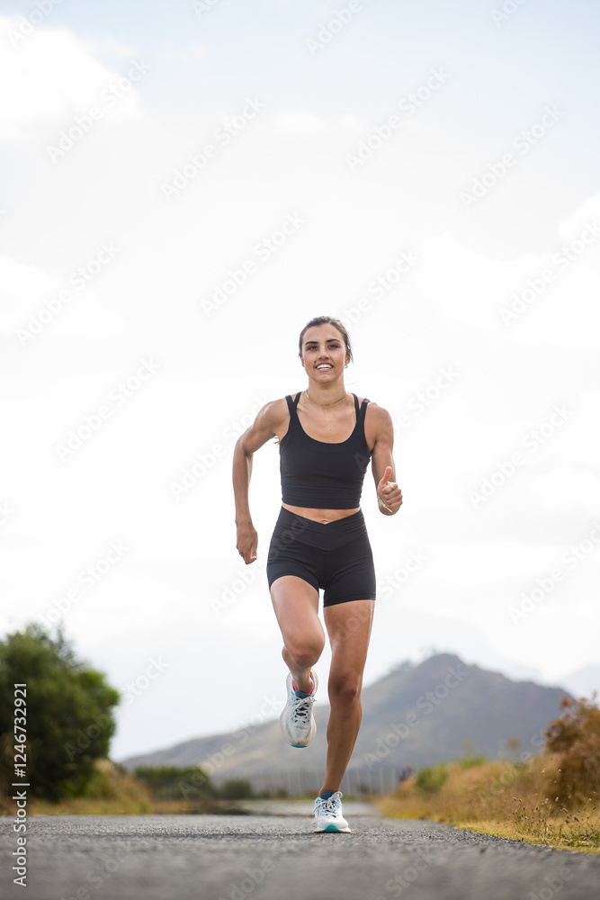 Female athlete in black sportswear running on a rural road with a scenic mountainous backdrop, emphasizing endurance and outdoor fitness. Female athlete in black sportswear running on a rural road with a scenic mountainous backdrop, emphasizing endurance and outdoor fitness.