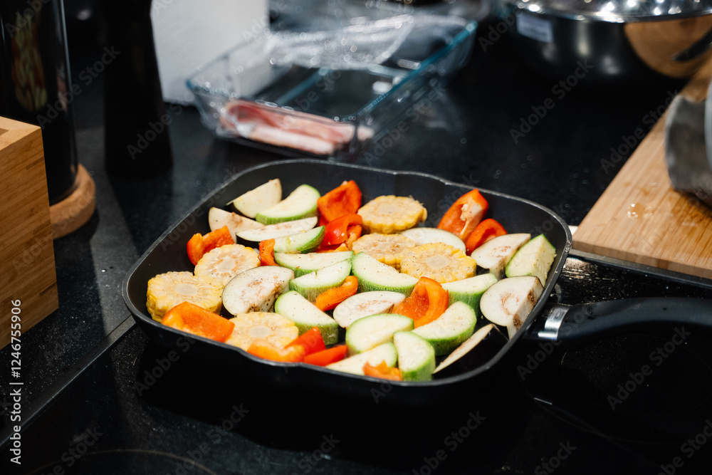 vegetables zucchini, tomatoes, eggplants are cooked in a grill pan