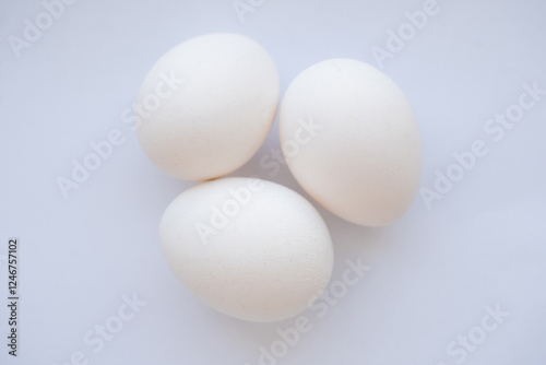 Obraz na płótnie three white chicken eggs on a white background w salonie