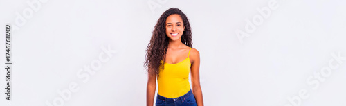 A healthy portrait of a smiling South American woman wearing yellow clothing against a white background.