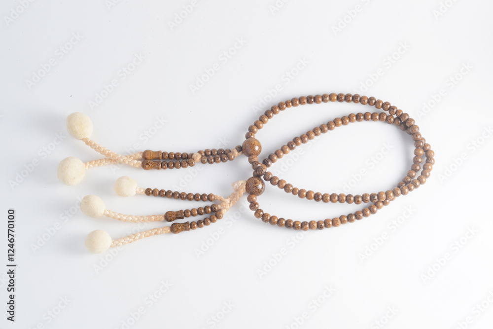 A wooden Juzu, a Japanese prayer beads, is a form of beadwork used to count the repetition of prayers, chants or mantras by members of various religions such as Buddhism and Shinto. A wooden Juzu, a Japanese prayer beads, is a form of beadwork used to count the repetition of prayers, chants or mantras by members of various religions such as Buddhism and Shinto.